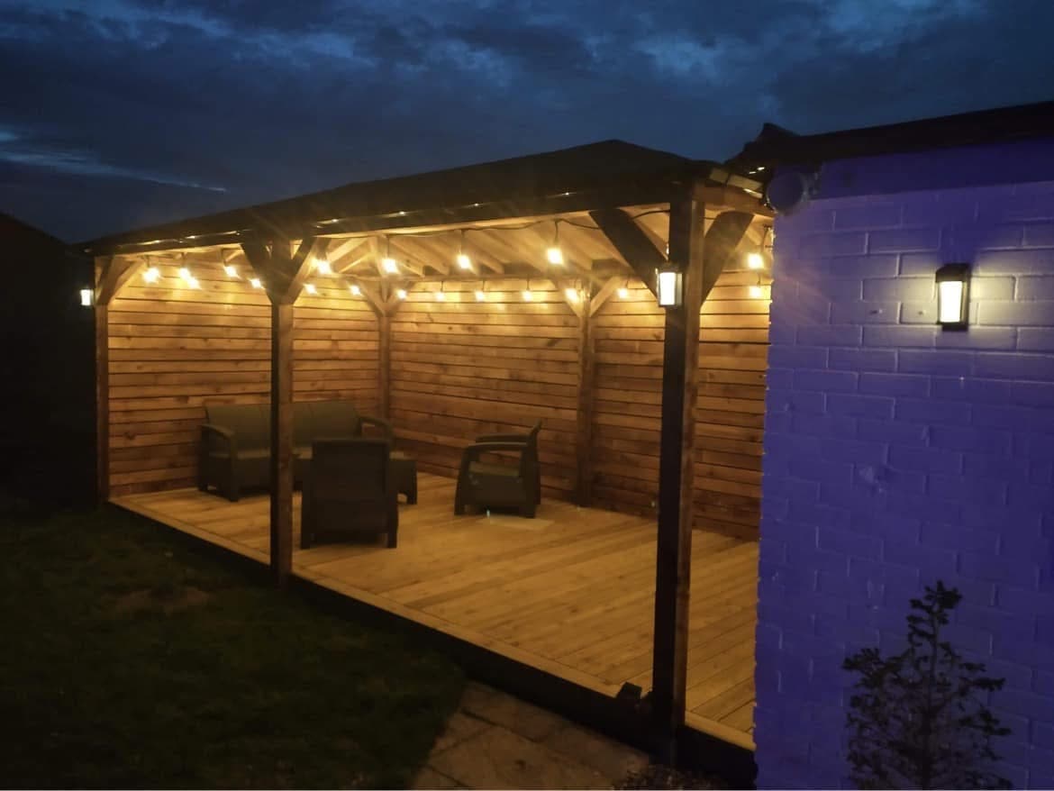 Timber-framed garden room with decking and French doors